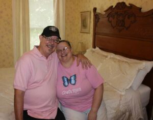 B&B owners pose in room