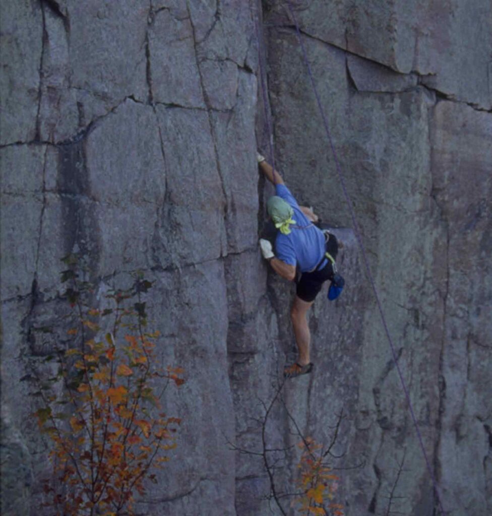 rock climber scaling rock wall