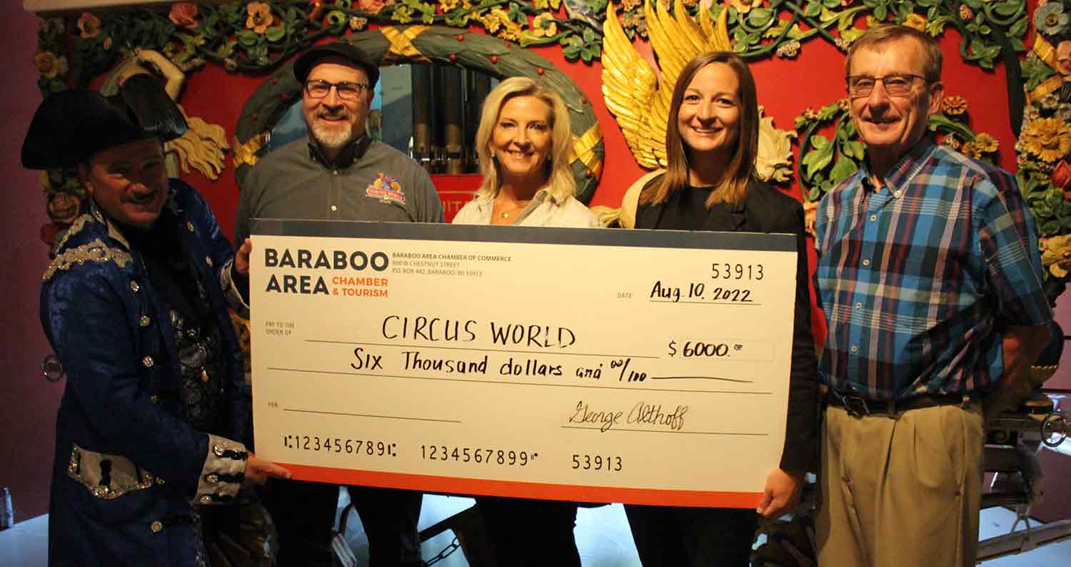 Parade Organizers Handing Oversized Check To Circus World Staff